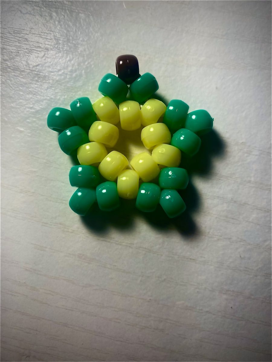 Star-shaped bead charm in green and yellow