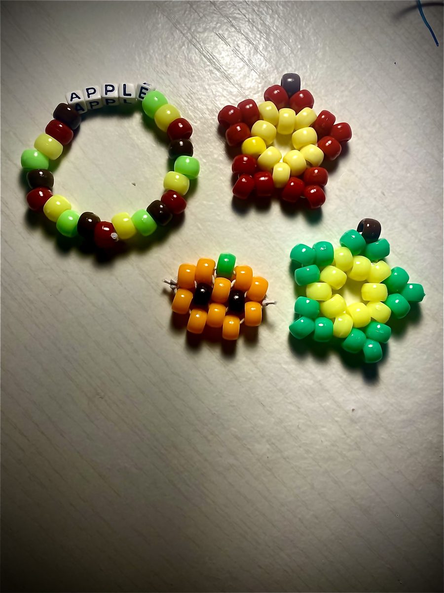 A spread of beaded charms and bracelets laid out on a table